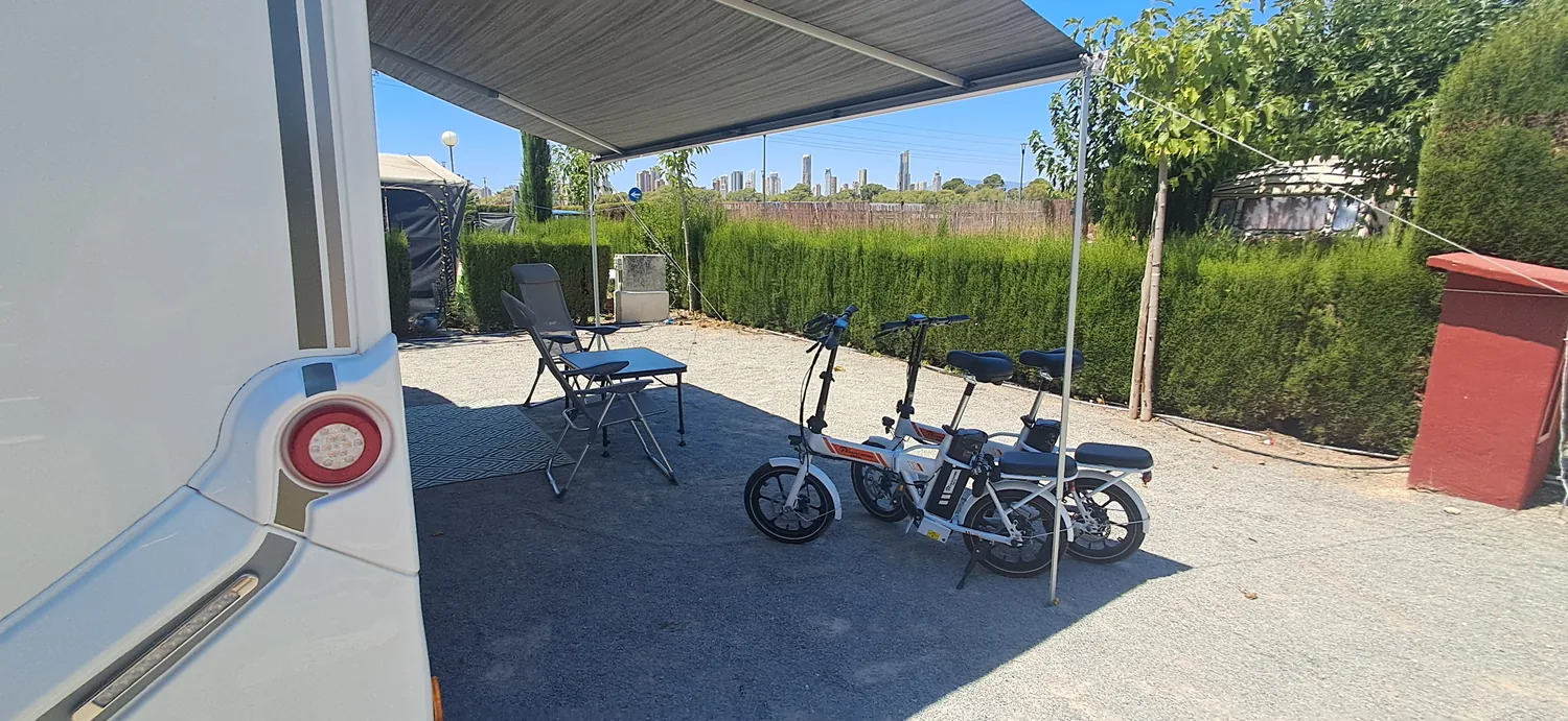 Seating area with e-bikes beside camper Benidorm