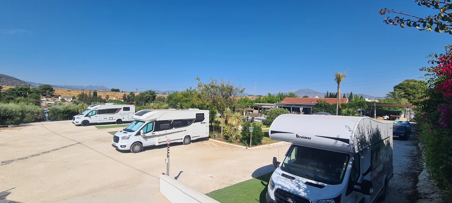 Camper pitches with mountain views and flowering bougainvillea