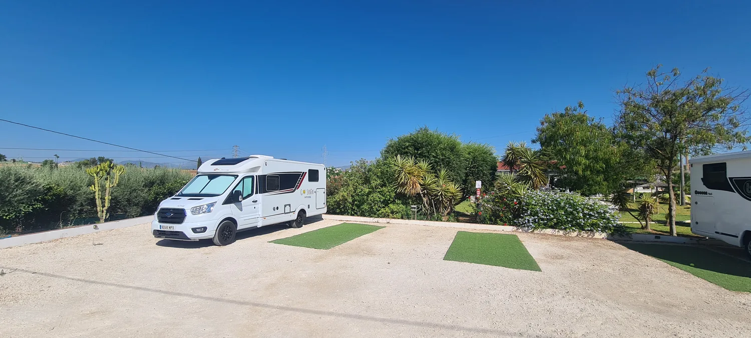 Spacious camper pitch with artificial grass